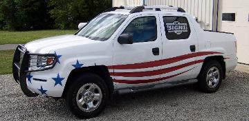 UCSIGNS truck with vinyl flag graphics